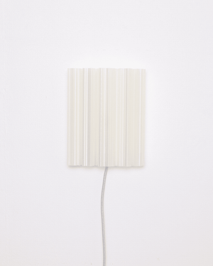 3D printed plug in wall light fixture with a rectangular, vertically ribbed off-white shade 