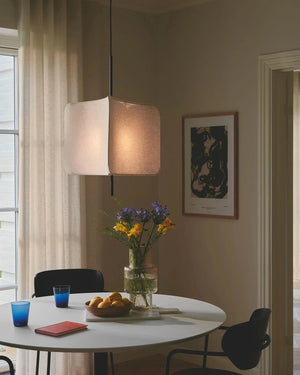Dining room with a round table, chairs, and a Modern Triangular Fabric Pendant 