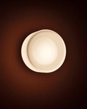 Round light fixture on a brown wall