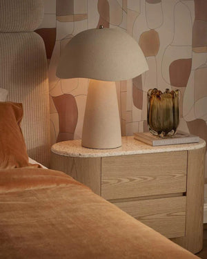 Organic Fibreglass Table Lamp in chalk on timber bedside table casting warm ambient glow in contemporary bedroom