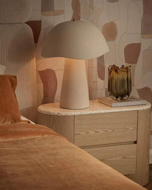 Organic Fibreglass Table Lamp in chalk on timber bedside table casting warm ambient glow in contemporary bedroom