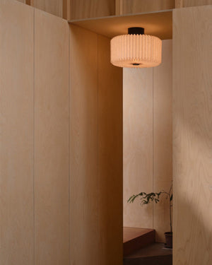 Pleated Fabric Ceiling Light mounted in plywood-panelled hallway casting warm diffused light downward