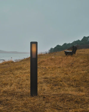 Ribbed Black Aluminium Cylindrical Garden Light set on a grass headland - Lighting Collective 