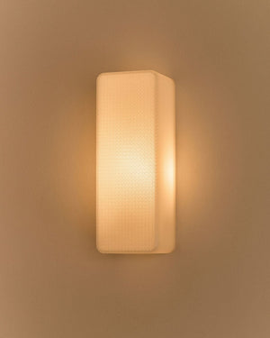 Side view of minimalist rectangular 3D printed wall light that is illuminated