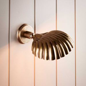 Rotatable Brass Shell Wall Light | Lighting Collective | on a white wall facing down