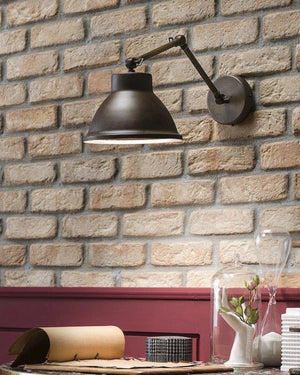 Rustic iron and brass wall light displayed in a restaurant