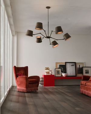 Rustic Iron Pendant Light displayed in a living room mixing modern bright furniture with old style couches