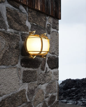 Brass Sea Bunker Industrial Wall Light on Stone Wall near the ocean - Lighting Collective 