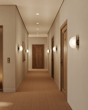 Modern hallway with light fixtures and wooden doors.