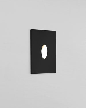 Black square wall light fixture on a gray background