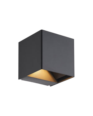 Warm light spilling from the underside of the black cube across its angled reflector.
