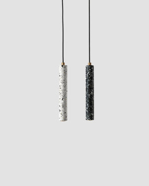 Two pendant lights with black and white cylindrical shades on a light gray background