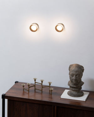 Thick Sandblasted Glass Wall Light pair illuminated on white wall above dark timber console table