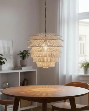 Tiered rattan pendant light in natural finish above dining room table