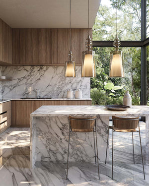 Mixed-size cluster of Italian Design Glass Pendants above marble table for warm accent kitchen lighting