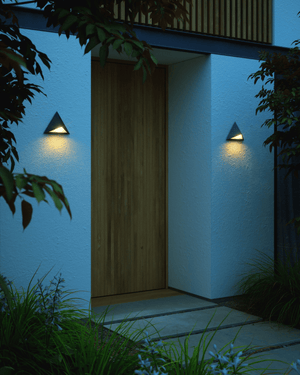 Modern house entrance with triangular outdoor wall lights on either side of the entrance on a dark evening - Lighting Collective 