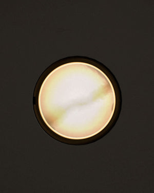 Round light fixture on a black background