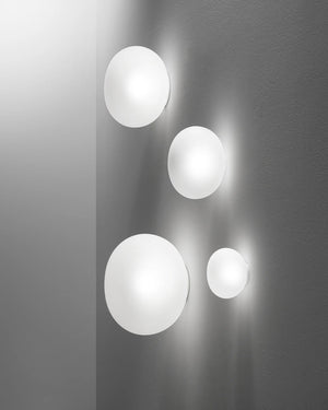 Set of four spherical wall lights on a gray wall