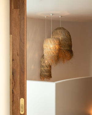 Pendants made from mendong grass hanging in stairwell
