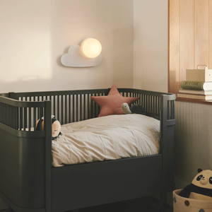 White Cloud Wall Light | Lighting Collective | near a kid’s bed turned on