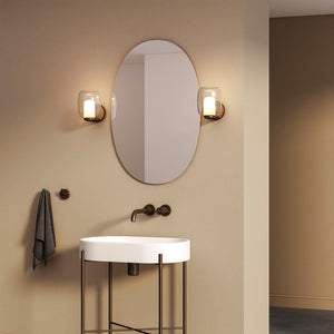 blown glass bathroom wall light matt black finish beside a mirror