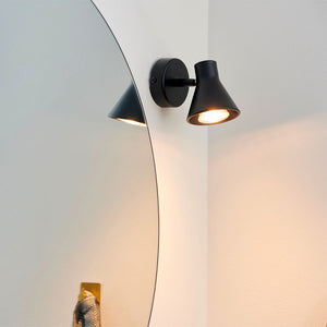 Contemporary Short Adjustable Wall Light black finish next to a mirror in a bathroom