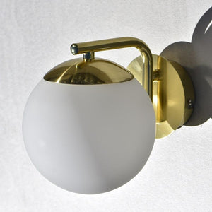 gold and sphere wall light