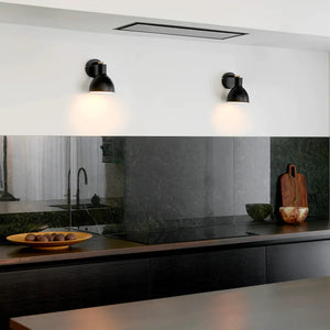 danish adjustable brass detailed wall light with black finish over a kitchen counter
