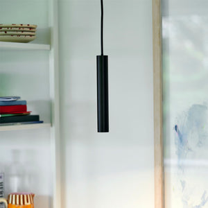 Minimalist Cylinder Pendant Light black finish in an office room
