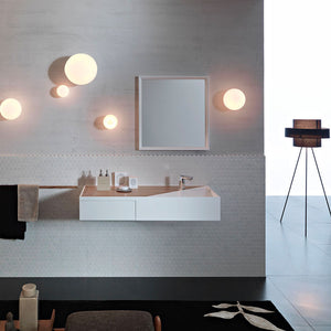 minimalist white frosted glass sphere wall lights in a cluster in a bathroom
