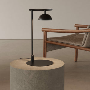 minimalist matte black table lamp on a concrete side table