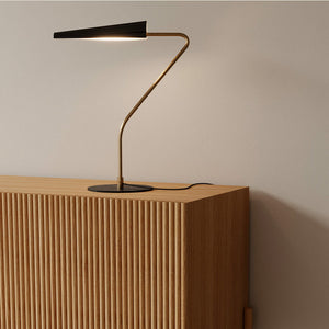 modern corrugated steel table lamp on a console table with black marble and aged gold structure
