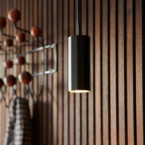 modern metal cylinder single pendant with black finish in an entrance hall