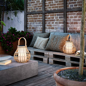 Organic Bamboo Outdoor Portable Lantern in a garden on a summer evening