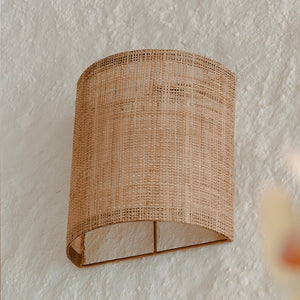 organic rattan half round wall light on a white wall