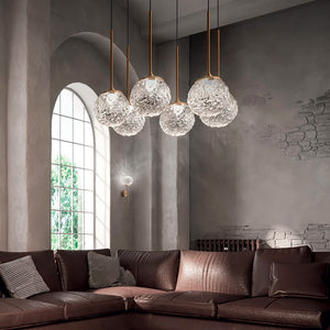 rippled glass sphere suspension light clear glass with brass frame suspended over a dining table medium size