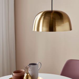 Scandinavian Brass Dome Pendant in a living room over a table