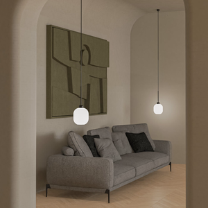 Elegant Curved Glass Pendant Light black and white finish in a living room next to a sofa