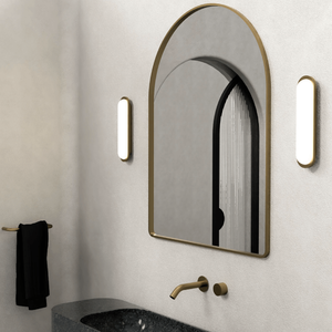 Elegant Elongated Glass Wall Light brass finish on both sides of a mirror in a bathroom